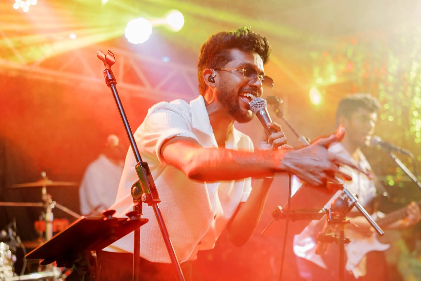 LOLLIPOP's lead singer on stage under orange lights